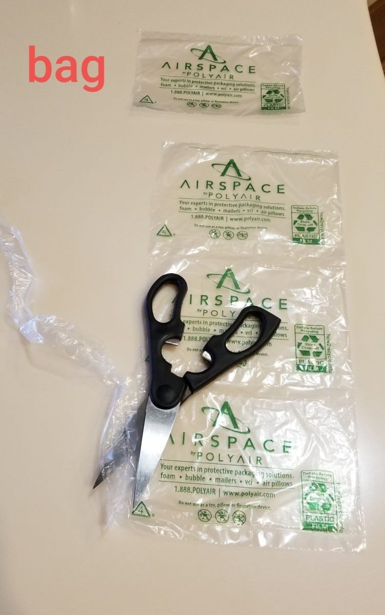Cutting open the air pillows to turn them into small bags. Cutting open the air pillows to turn them into small bags.