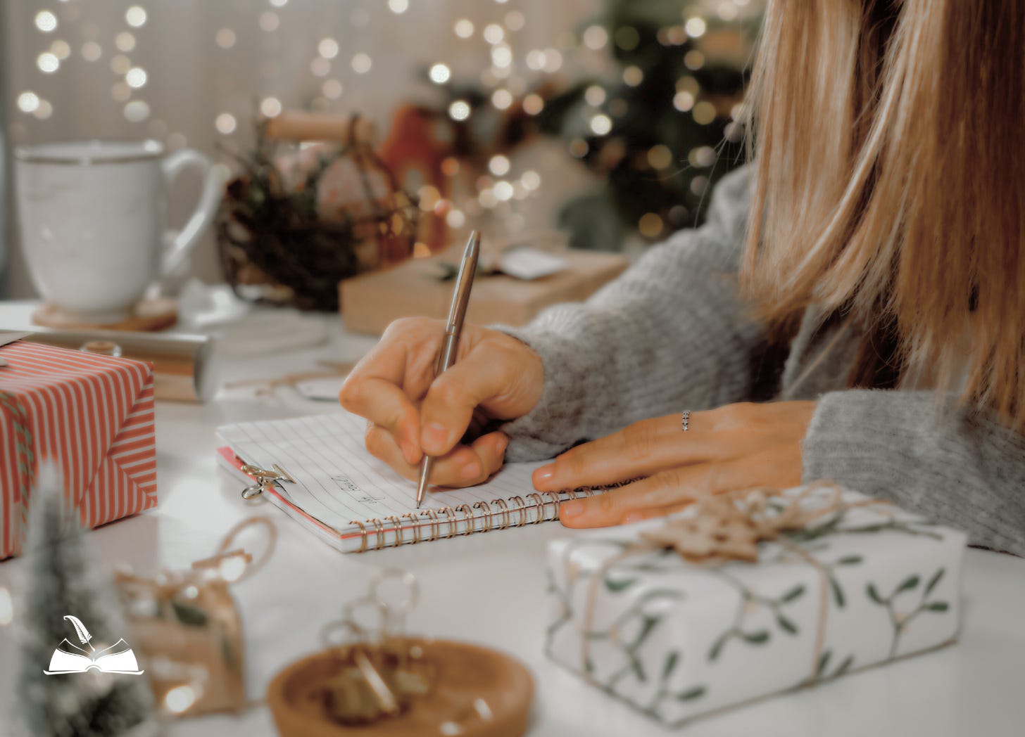 A Christian writer writing in her Christmas journal with twinkling Christmas lights in the background and wrapped gifts and clutter surrounding her
