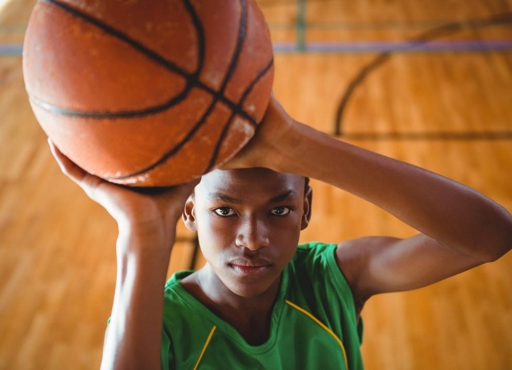 Teen Boy Practicing Basketball on Indoor Court - Free Stock Photo |  Pikwizard