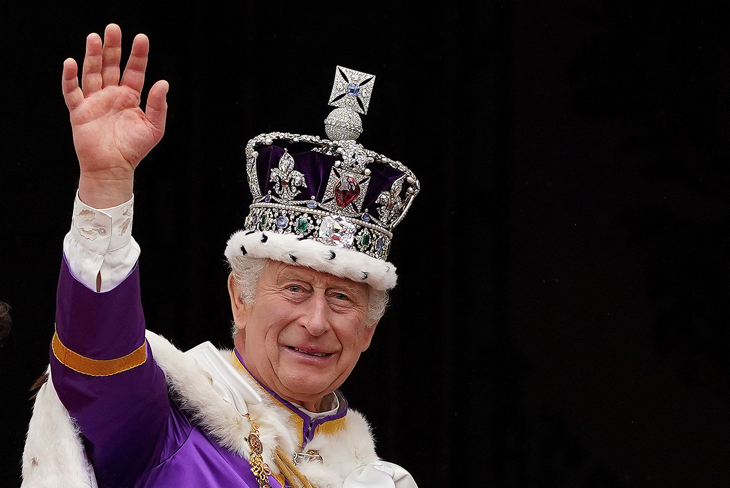 King Charles waves from the balcony after his coronation.