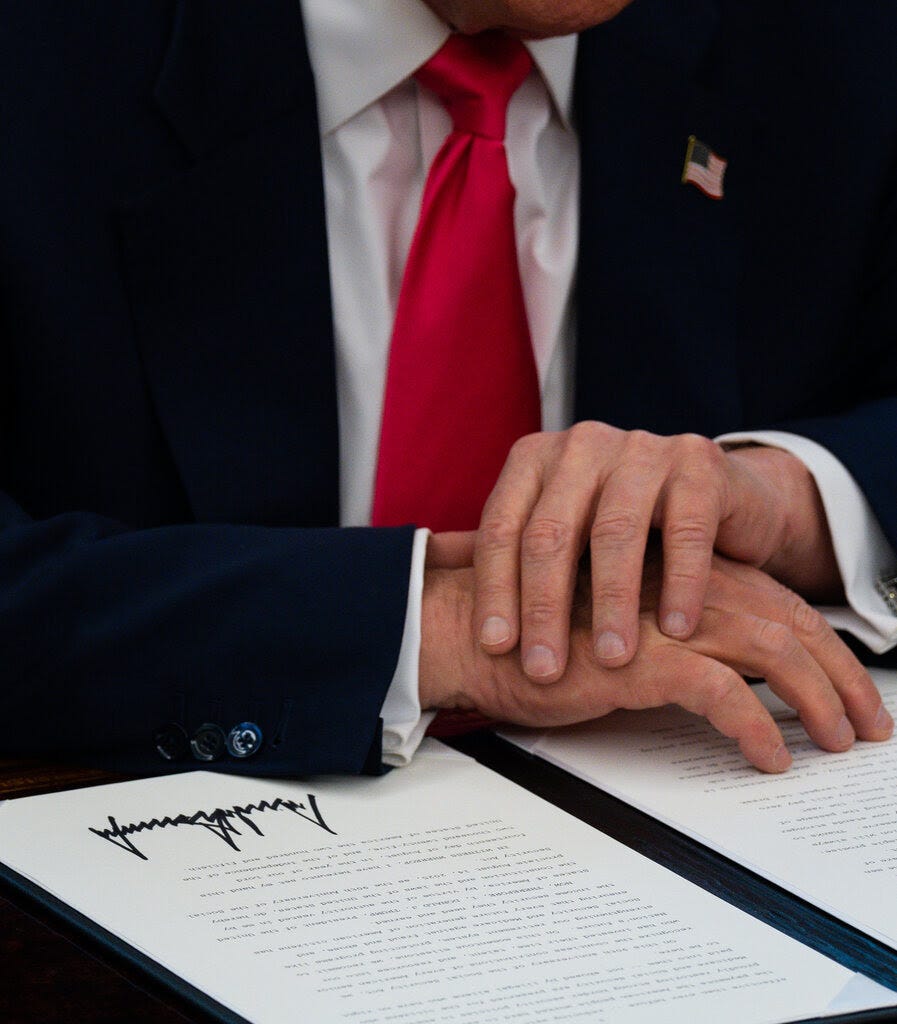 A close-up of President Trump’s hands, which are resting on an order he has signed.