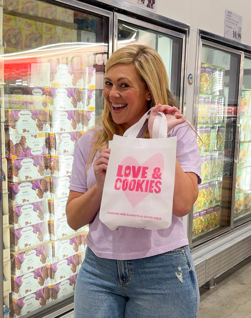 Ashley holding a Love & Cookies bag in the freezer isle of a grocery store Ashley holding a Love & Cookies bag in the freezer isle of a grocery store