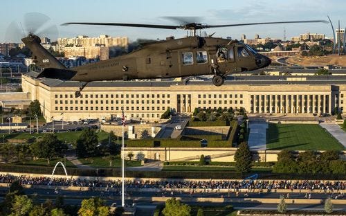A helicopter flies over a road race along the highway outside the Pentagon.