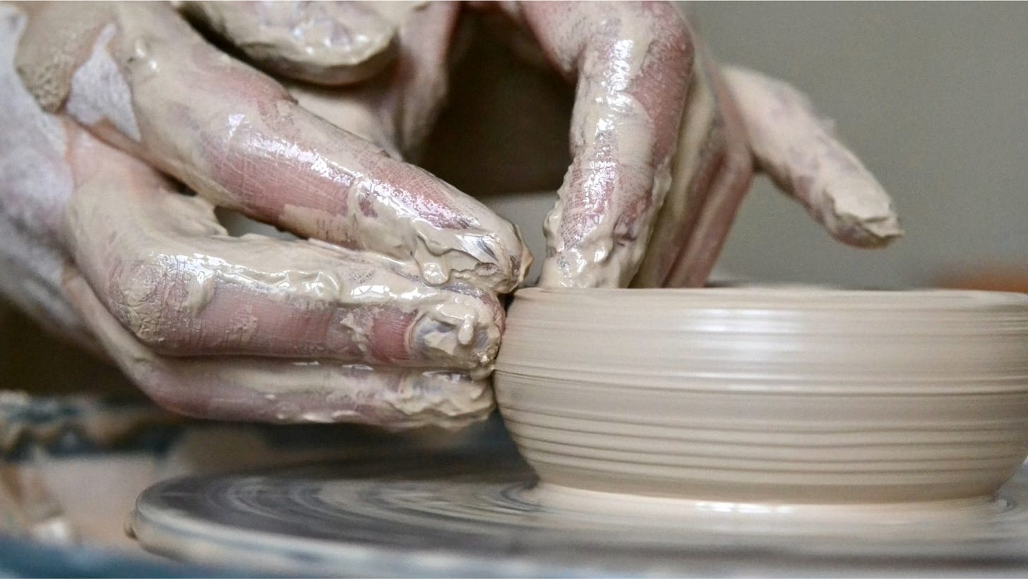 hands making a clay pot