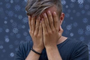 boy covering his face in shame