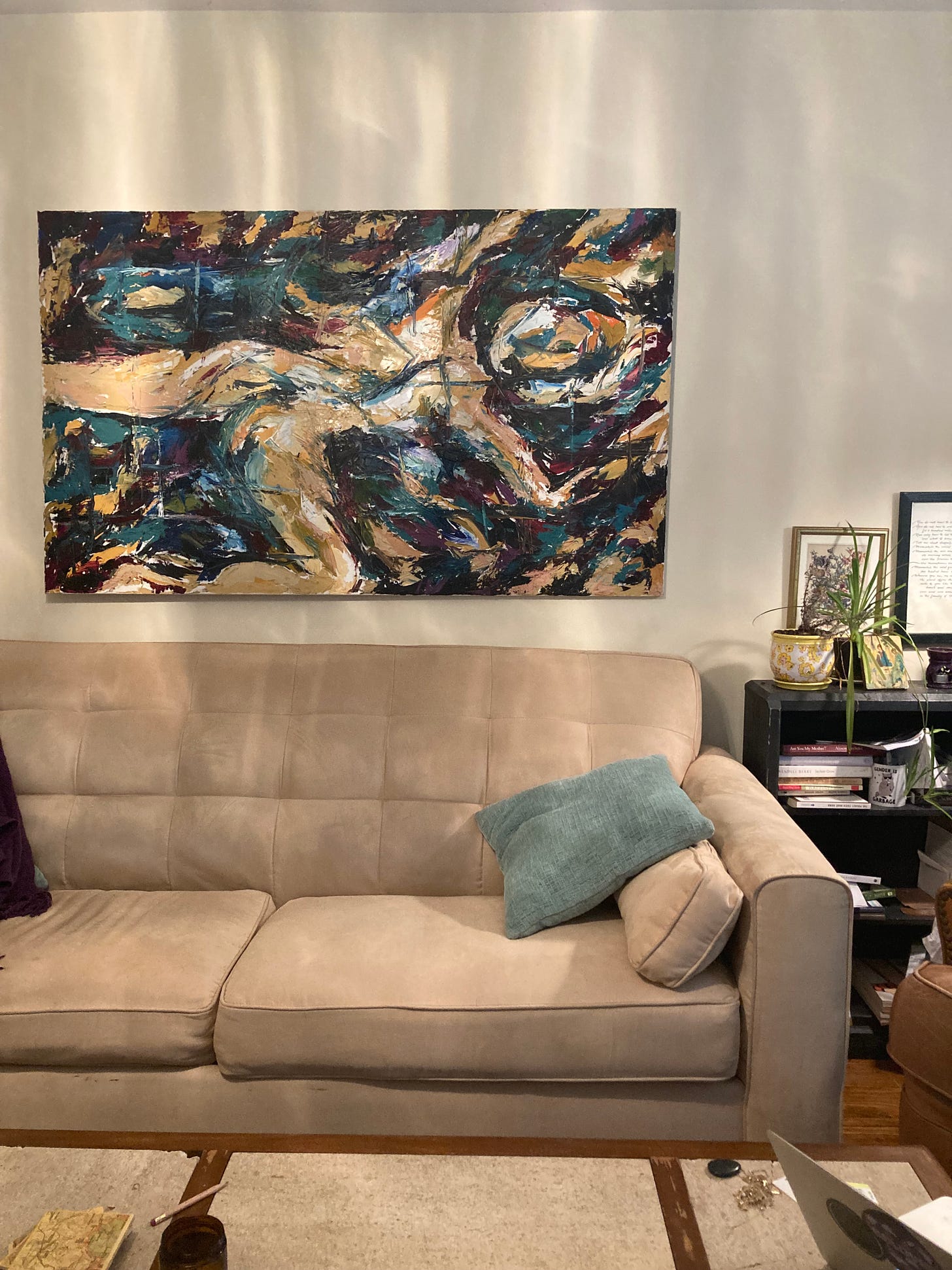 The same picture, now hanging over my cozy couch in my living room. Now, though, she is hung horizontally, and it looks like she is swimming through a teal and purple river