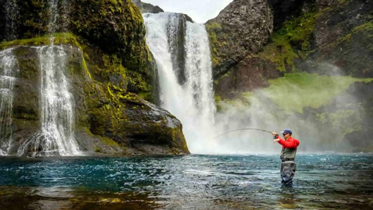 Angler with Fish On Near Waterfalls