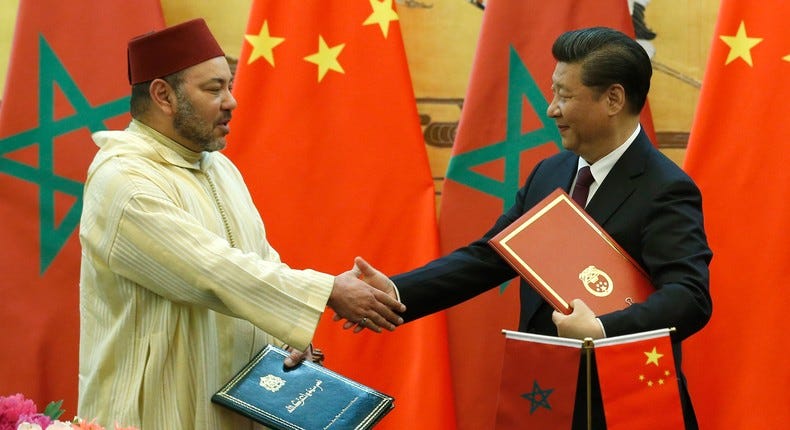 China's President Xi Jinping (R) and Moroccan King, Mohammed VI, shake hands after signing documents during a signing ceremony at the Great Hall of the People in Beijing on May 11, 2016. [Photo credit should read KIM KYUNG-HOON/AFP via Getty Images]
