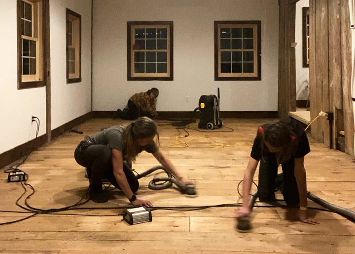 A photograph of us working on the floor which turns out to replicate the famous painting, The Floor Scrapers by Gustave Caillebotte