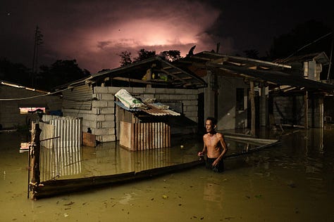 (1) A resident wades through a flooded street caused by heavy rains from typhoon Toraji in Ilagan City, Isabela province, northern Philippines, on Nov. 12.Noel Celis—AP. (2) A local resident helps free a car that became stranded in a stretch of flooding road as Tropical Storm Helene strikes, on the outskirts of Boone, N.C., on Sept. 27.Jonathan Drake—Reuters. (3) A woman looks out from her balcony at vehicles trapped in the street by flooding in Valencia, Spain, on Oct. 30.Alberto Saiz—AP. (4) An aircraft sits on the flooded tarmac of Salgado Filho International Airport in Porto Alegre, Brazil, on May 20. Anselmo Cunha—AFP/Getty Image. (5) Melting ice in West Antarctica, Feb. 10th. In 2024, the El Niño phenomenon intensified warmer ocean currents near West Antarctica, accelerating ice melt under the floating ice shelves. This warming is associated with a weakening of easterly winds that normally help keep warmer waters away from the Antarctic shelf. With weaker winds, more Circumpolar Deep Water—naturally warmer, deeper ocean water—reached the ice shelves, where it melted ice from below, increasing sea-level rise risks globally.Jasper Doest. (6) In August, a large fire front advances over the Pantanal, the largest tropical wetland on the planet. The South American region, located largely in southwestern Brazil, has been facing a historic drought due to human actions and climate change. Lalo de Almeida—Panos Pictures.