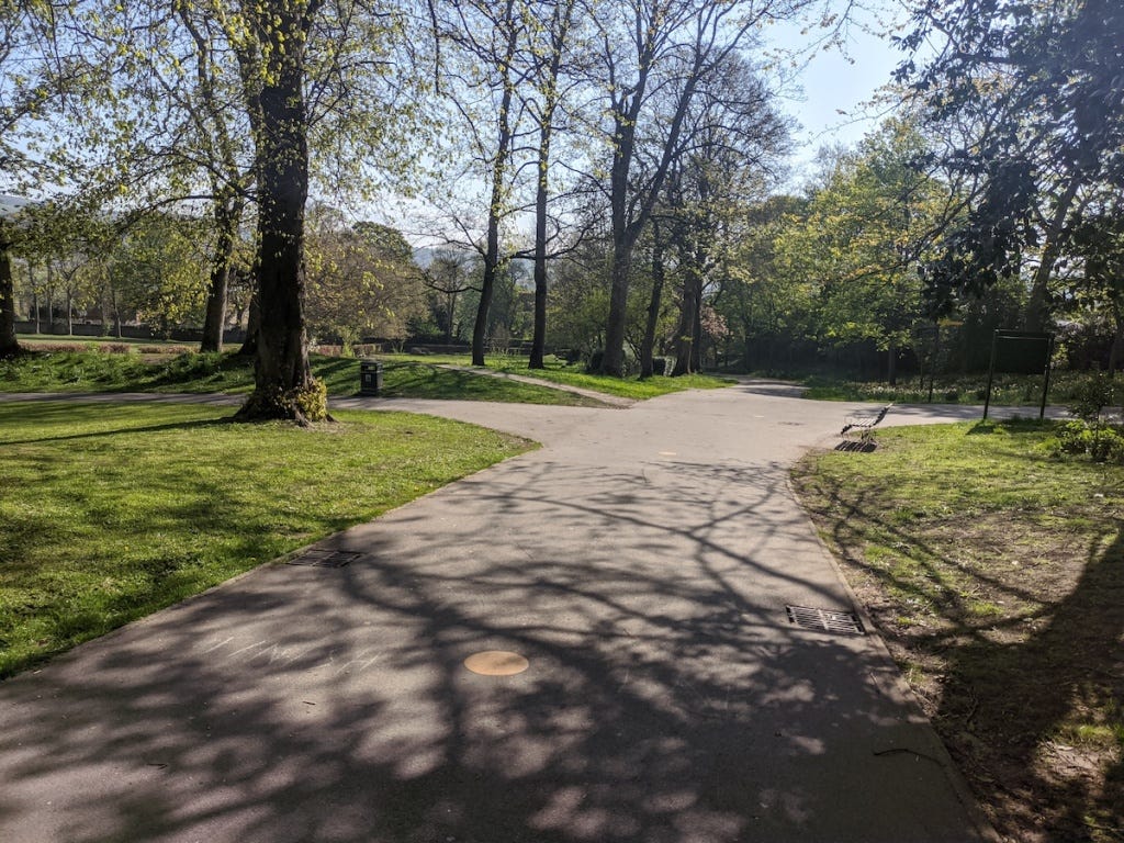 Wide tarmacced path with other paths leading off to left and right.