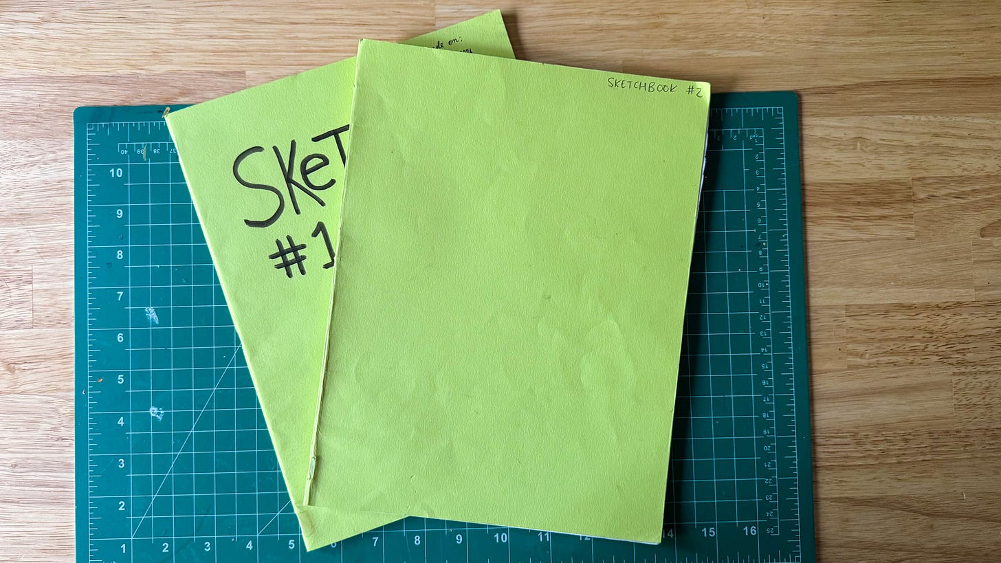 two printer paper notebooks on a desk