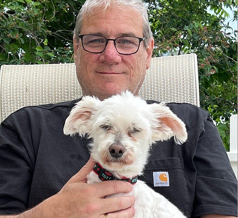 White Havanese with various family members who are all smiling