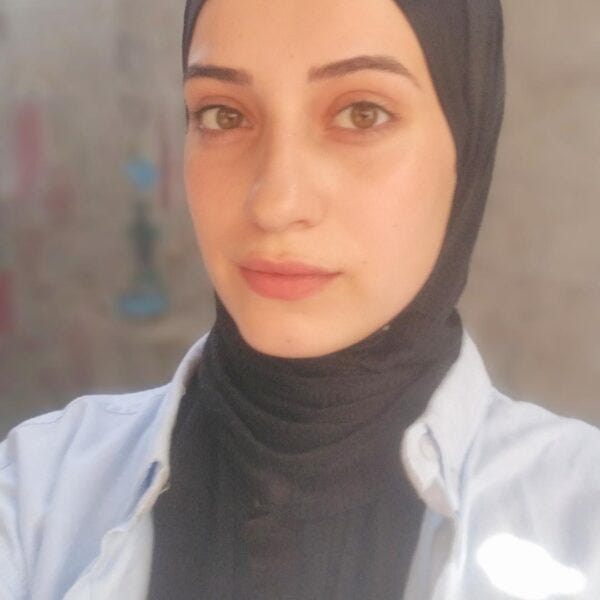 Young woman in white jacket and black hijab. Young woman in white jacket and black hijab.