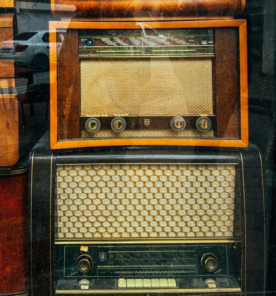 a bunch of old radio's sitting in a window a bunch of old radio's sitting in a window