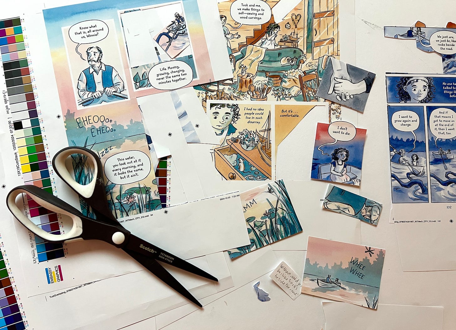 Photograph of graphic novelist K. Woodman-Maynard's desk as she works on a collage with proofs from the Tuck Everlasting graphic novel. 