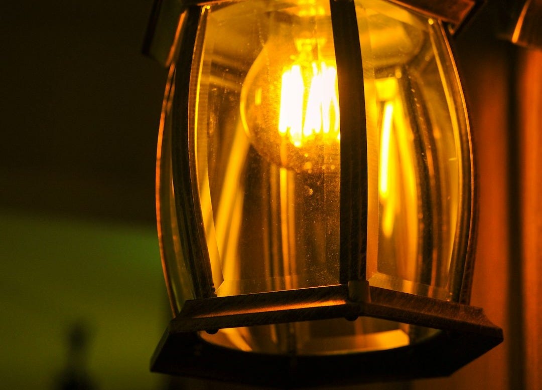 A close up of a light hanging from a ceiling