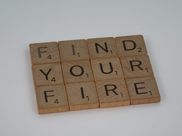 The inscription FIND YOUR FIRE written on wooden pieces.