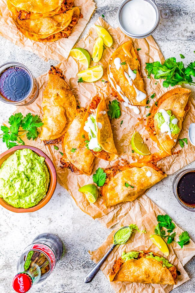 Cauliflower Tinga Tacos with Avocado Crema - Roasted cauliflower is drenched in a smoky, perfectly spicy chipotle sauce, then folded into corn tortillas, cheese is added, and baked to crispy perfection! A bright avocado crema sauce is the finishing touch! Naturally gluten-free vegetarian food never tasted so AMAZING! You'll never miss the meat in these healthy tacos!