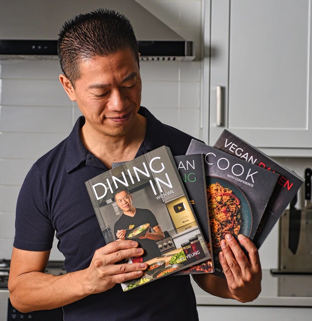 Wil Yeung holds several of his own cookbooks