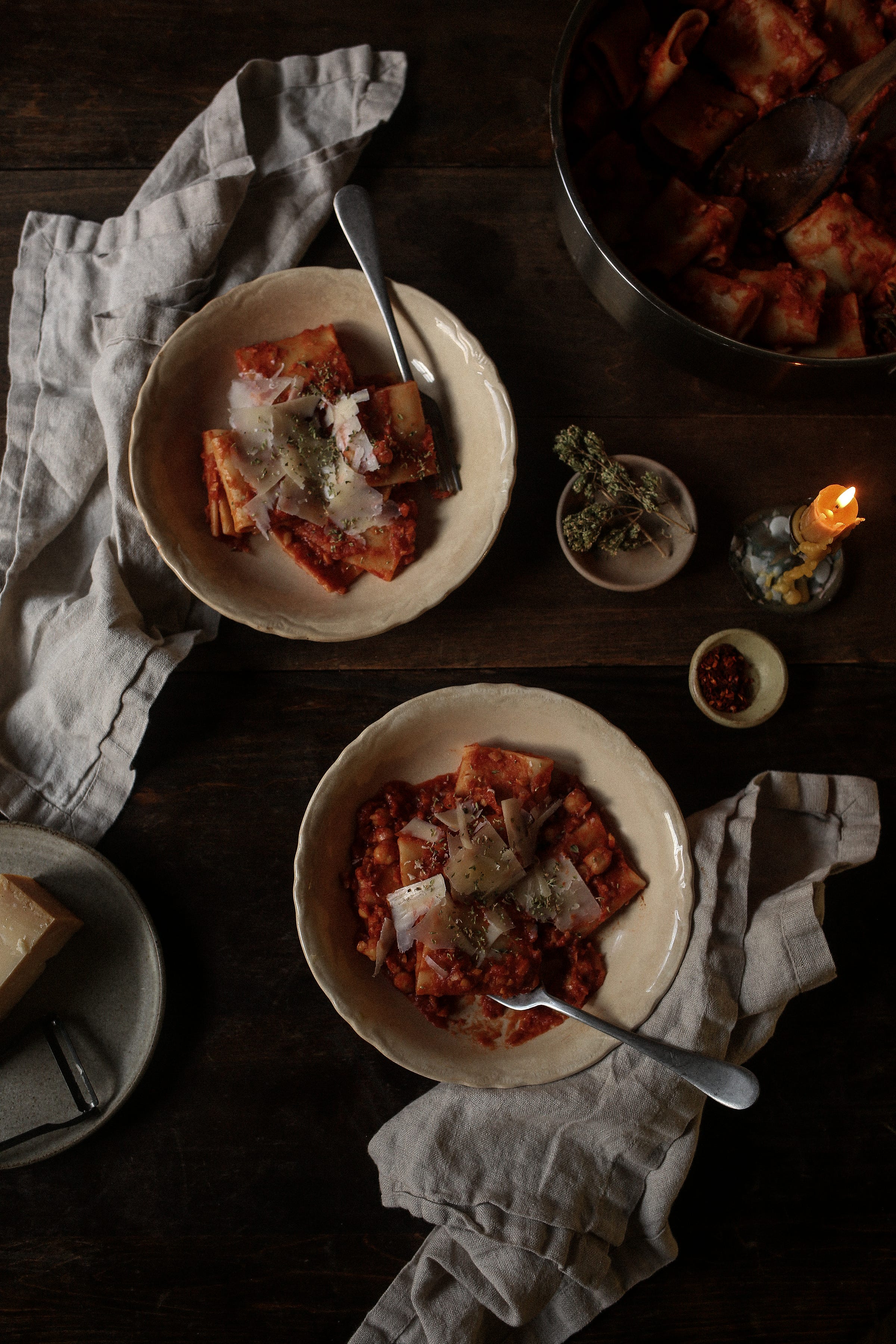 Pasta with chickpeas plated and served on a table with linen napkins
