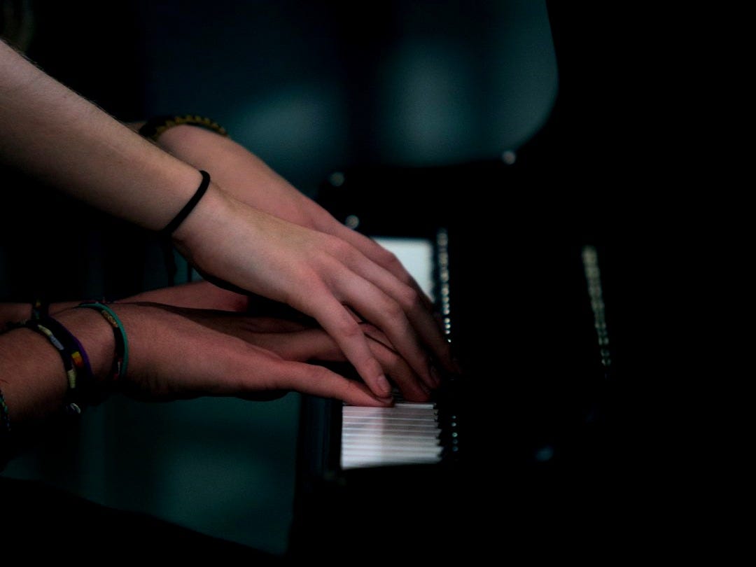 two person playing piano