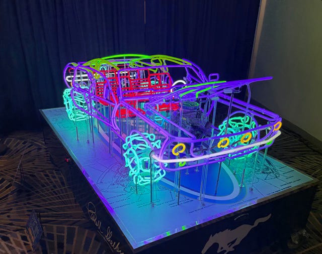 Who's the man building 3D neon cars?