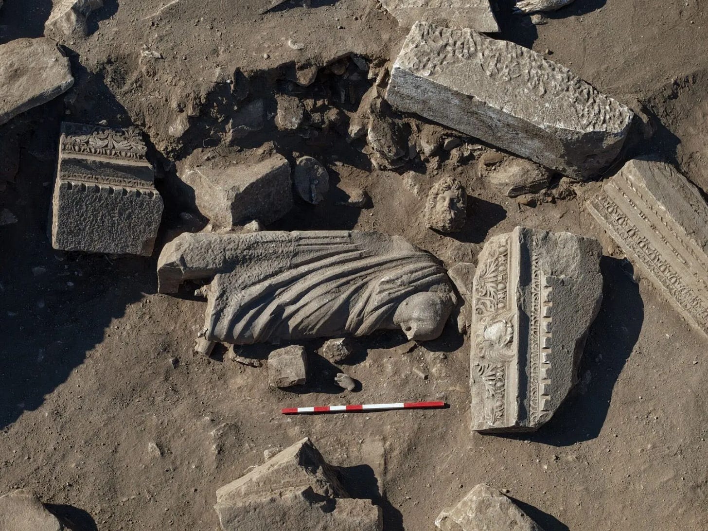 The statue in situ among the collapse debris of the Monumental Gate at Aspendos, lying amid carved architectural blocks from the structure. The statue in situ among the collapse debris of the Monumental Gate at Aspendos, lying amid carved architectural blocks from the structure.