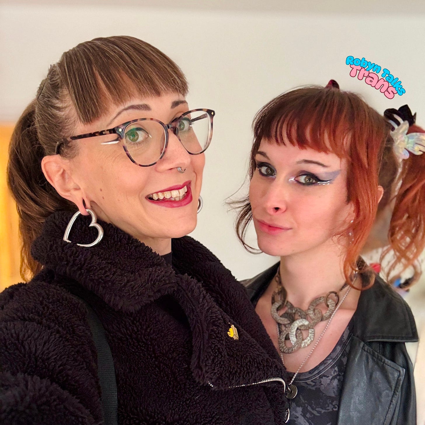 A photo of Robyn and Felicity holding one another and smiling at the camera. They are dressed up for a night out A photo of Robyn and Felicity holding one another and smiling at the camera. They are dressed up for a night out