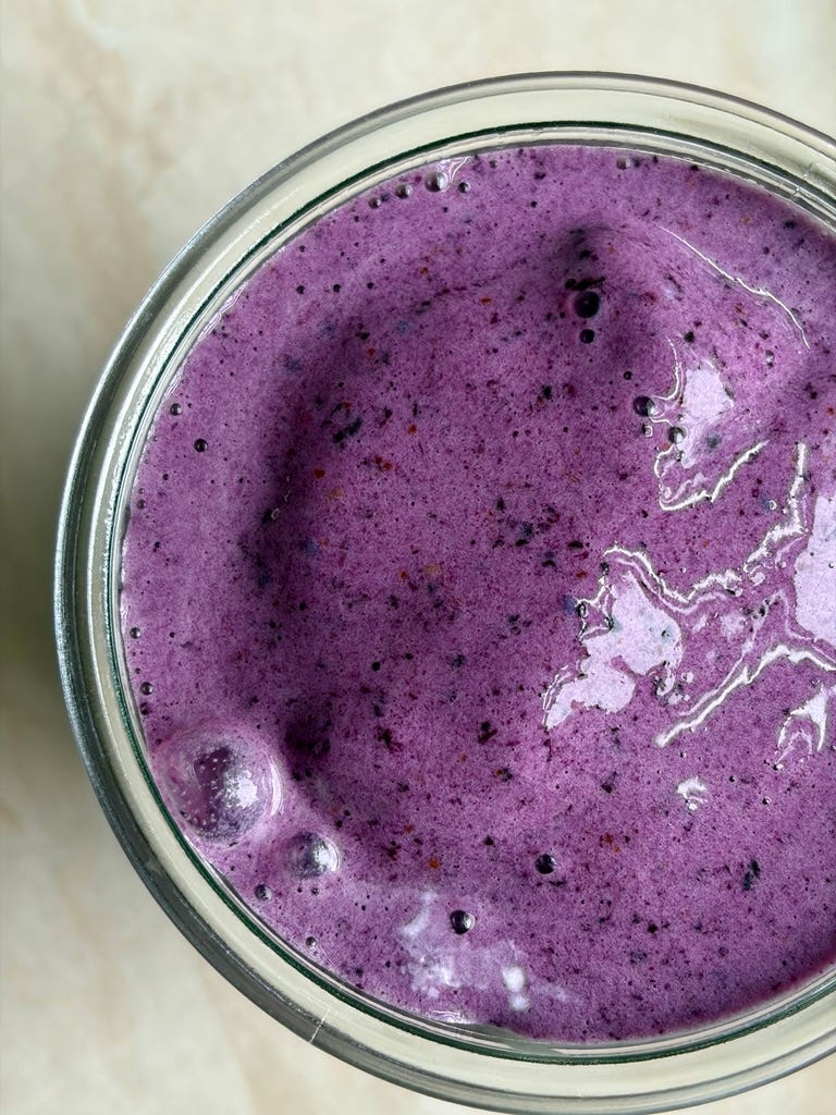 An antioxidant boosting smoothie with creamy bananas, frozen blueberries, and maca powder in a glass jar