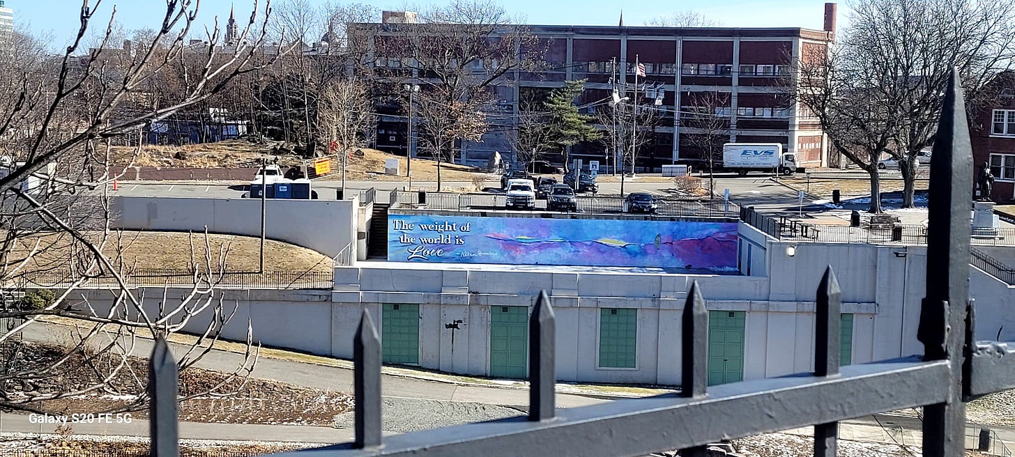 Mural that says "The weight of the world is Love"