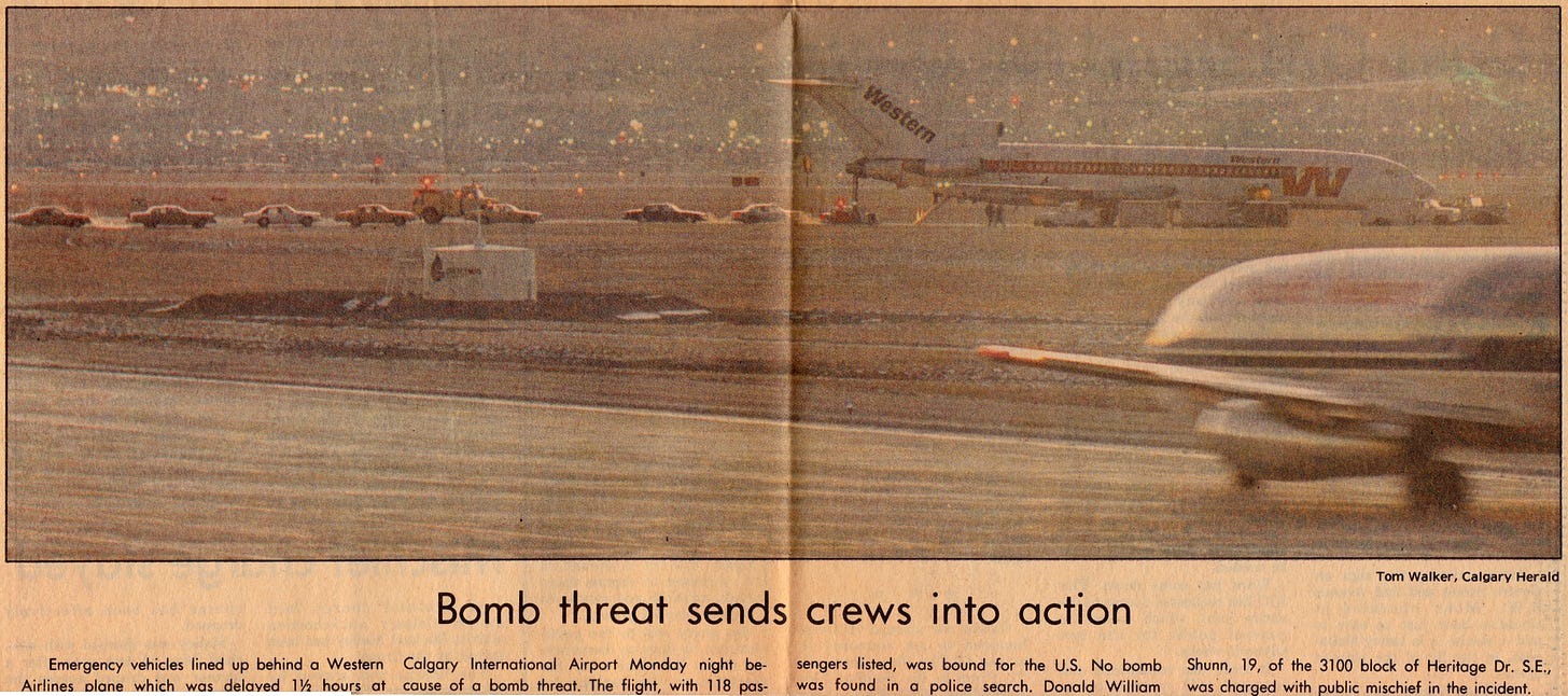 A yellowed newspaper scan from 1987, showing a color photograph of a Western Airlines plane parked on a runway with a lot of emergency vehicles lined up behind it. The caption below the photo says "Bomb threat sends crews into action."