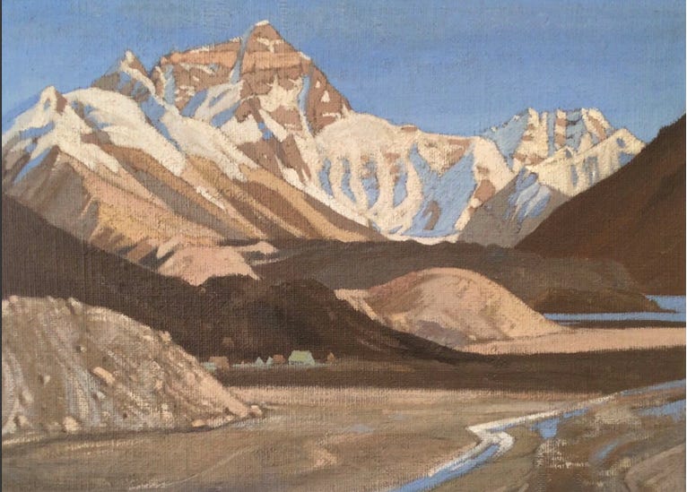 small green tents below mountain