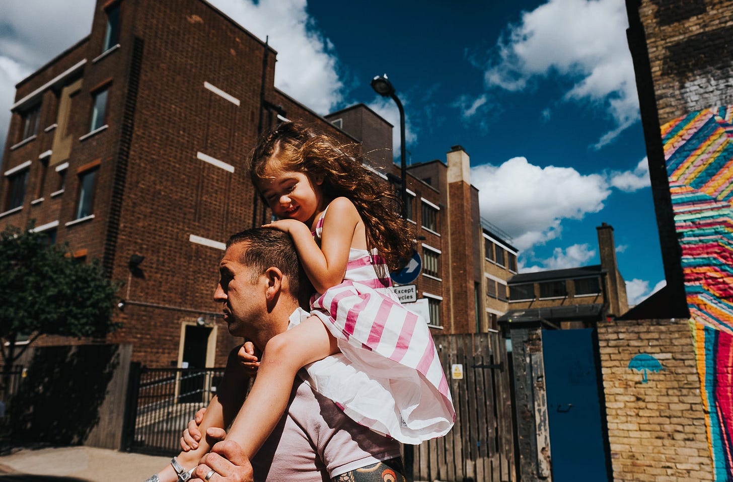 family photo shoot in shoreditch street art girl on dad fathers shoulders