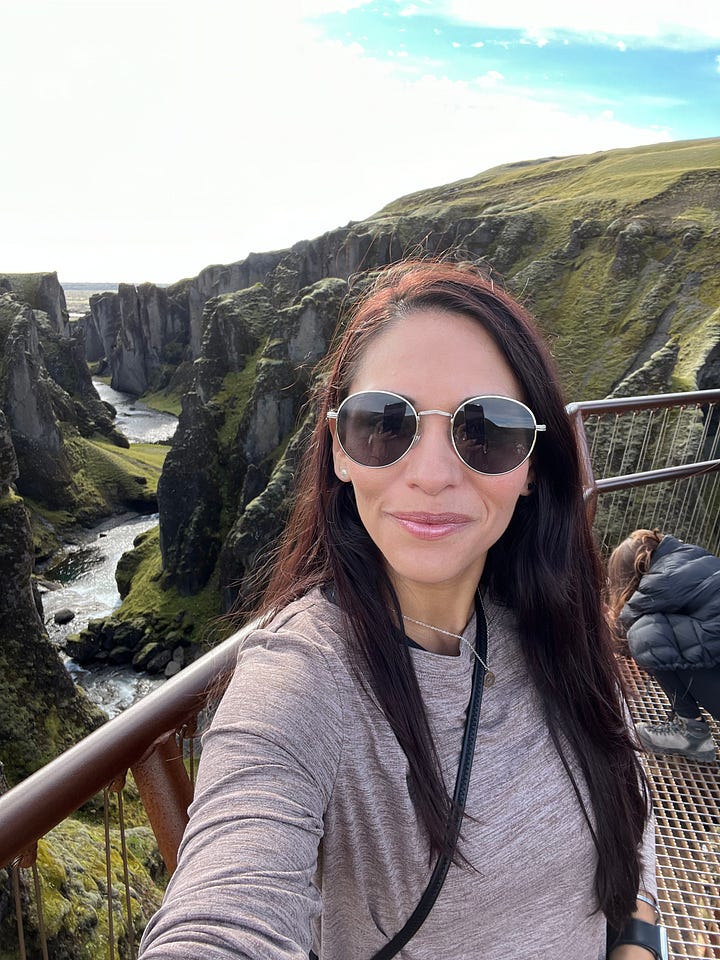 Counter-clockwise from top left: woman near base of the Seljalandsfoss waterfall as it pours into a small lake; selfie photo of woman near base of the Skogafoss waterfall, with a rainbow behind her and in front of the waterfall; selfie photo of woman from a view point with Fjadrargljufur canyon below and behind her; selfie photo of woman with strong winds blowing up from the Gullfoss waterfall behind and below her.