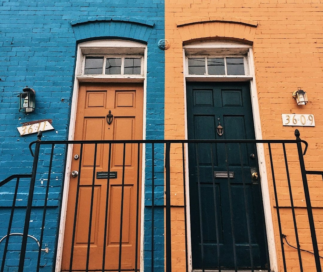 a blue building with a black door a blue building with a black door