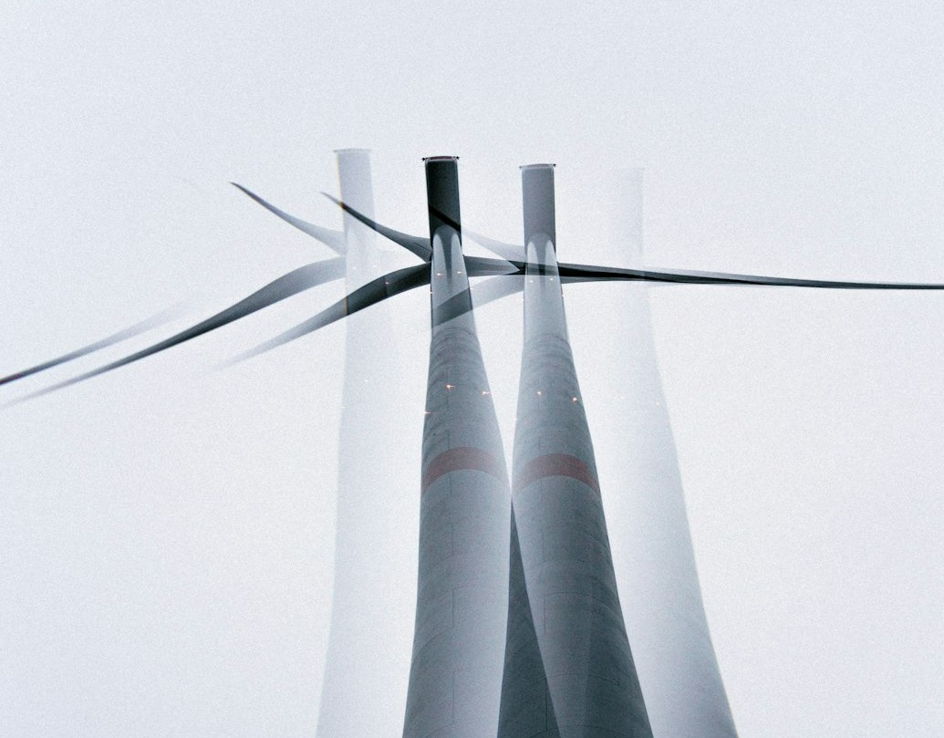a group of wind turbines with a sky background