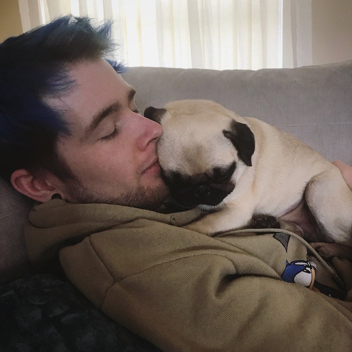 Photo of DanTDM cuddling with a tan pug dog Photo of DanTDM cuddling with a tan pug dog