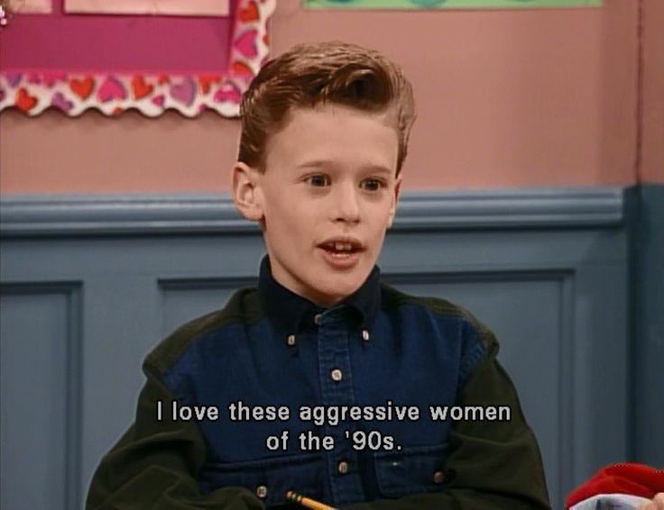 This may contain: the young boy is sitting in front of a desk with a note on it that says i love these aggressive women of the'80s