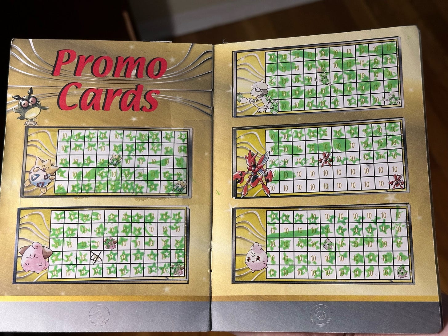 Inside Greg's badge book, showing progress towards obtaining promo cards Togepi, Cleffa, Smeargle, Scizor, and Igglybuff Inside Greg's badge book, showing progress towards obtaining promo cards Togepi, Cleffa, Smeargle, Scizor, and Igglybuff