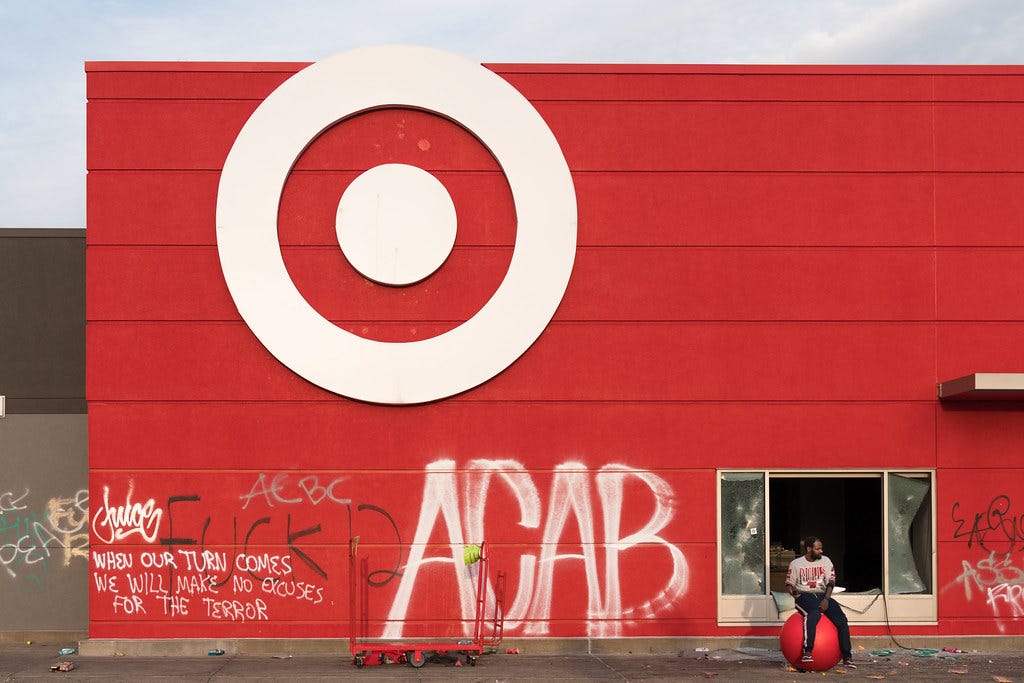 A man sits on a Target ball in front of the store on Thurs… | Flickr A man sits on a Target ball in front of the store on Thurs… | Flickr