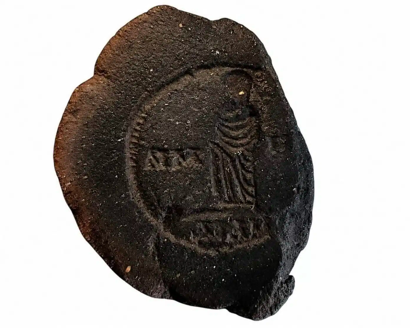 A clay mold used for minting coins A clay mold used for minting coins