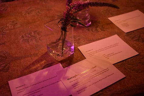 pictures of author signing book at book launch event, and aesthic placement of candles, dim light, and books displayed in accordion style