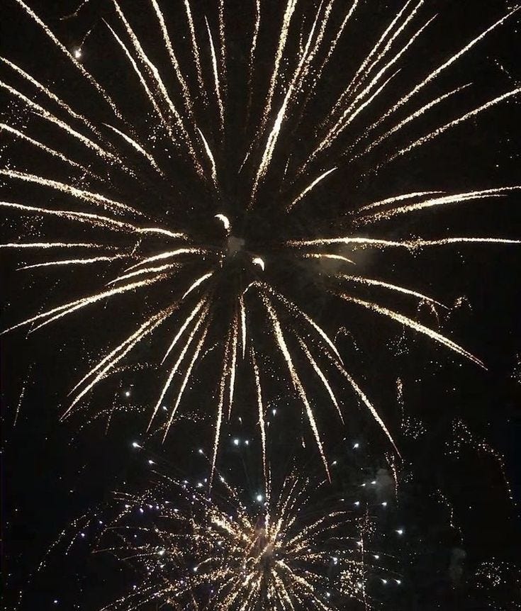This may contain: fireworks are lit up in the night sky