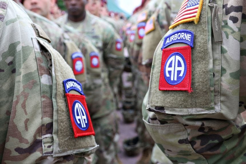 Paratroopers of the 82nd Airborne Division stand in formation in the town square of Sainte Mere Eglise, France, in June 2019.