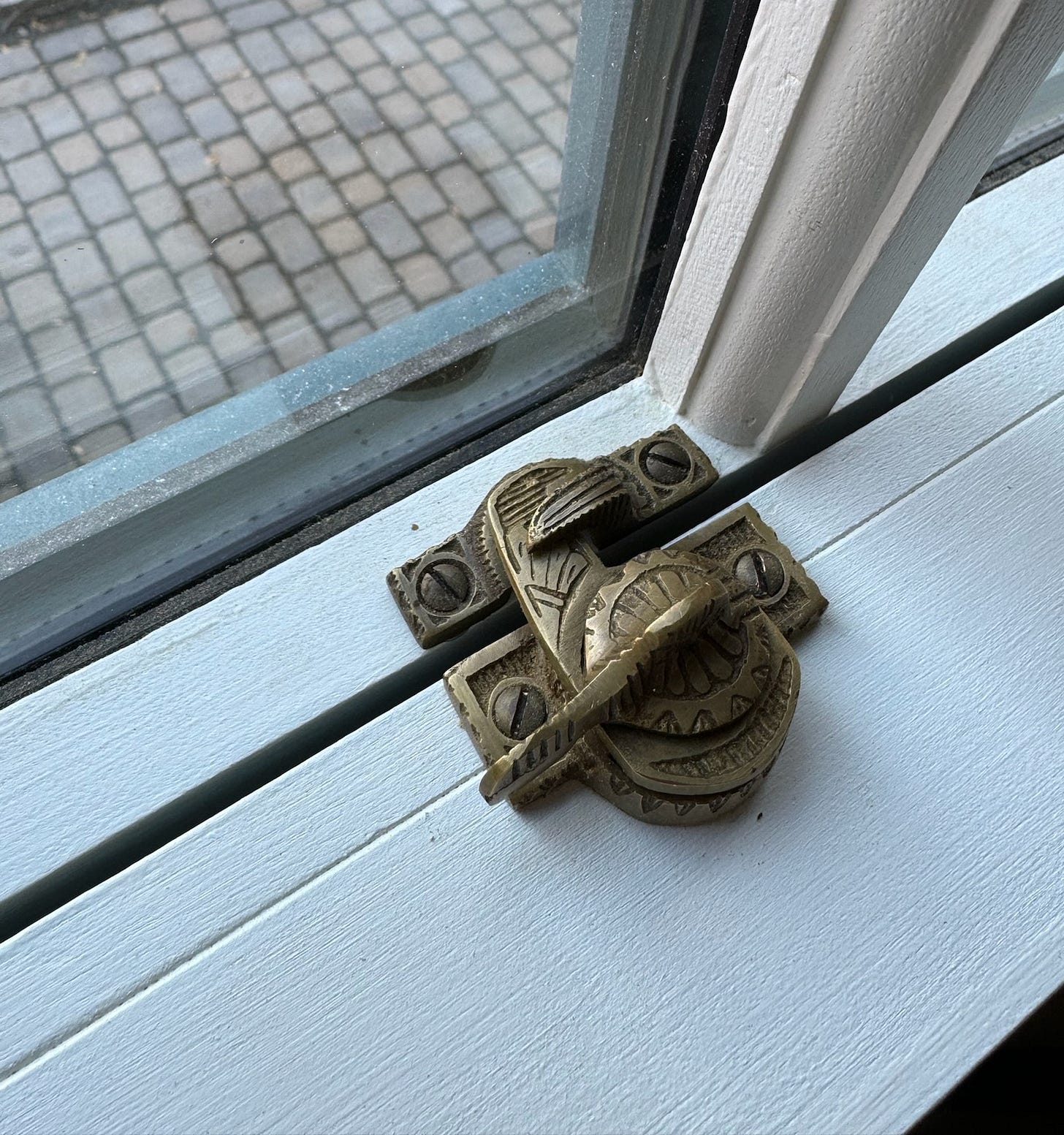 An exact reproduction of the home’s only surviving original sash lock, recast in old brass from the 19th-century pattern found on site.