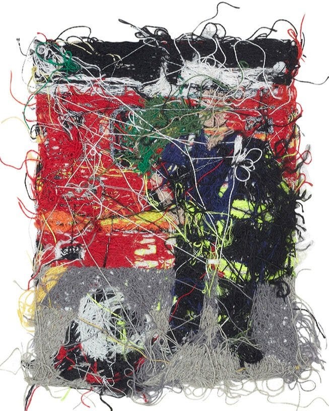 1) A white firefighter is standing in front a red firetruck with a green wreath on the front of it. The firetruck is from New York, and the firefighter has their jacket off. The person has short black hair and is smiling at the viewer. Their fire coat is black with yellow highlights. 2) The reverese of the embroidery is seen with threads and strings going different directions.