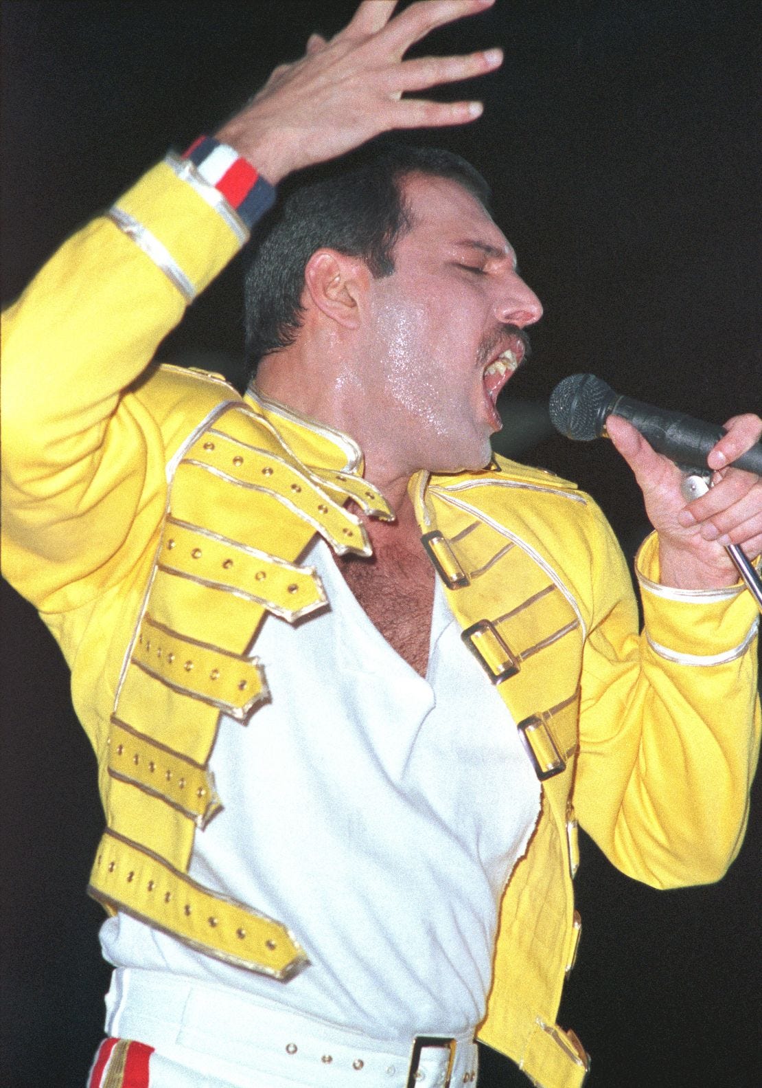 Freddie Mercury performs on stage at Wembley Stadium. Freddie Mercury performs on stage at Wembley Stadium.