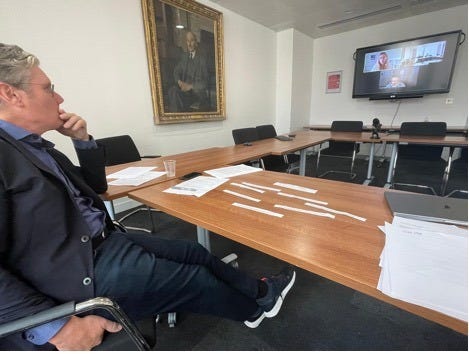 A person sitting at a table with papers on it

AI-generated content may be incorrect.