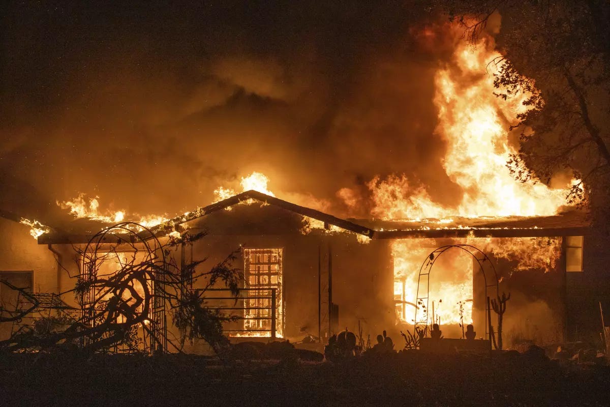 Small Spanish style home engulfed in flames.